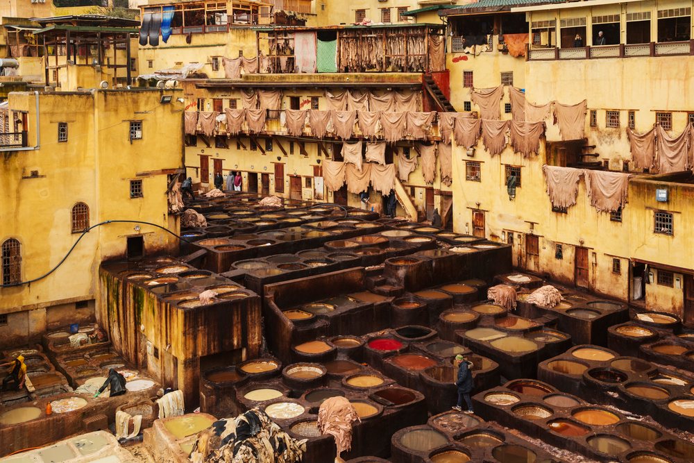 Chouara Tannery, features leather processing in large outdoor dye vats under pouring rain, Landscape, Lifestyle, Fes, Fes-Meknes Administrative Region, Morocco.