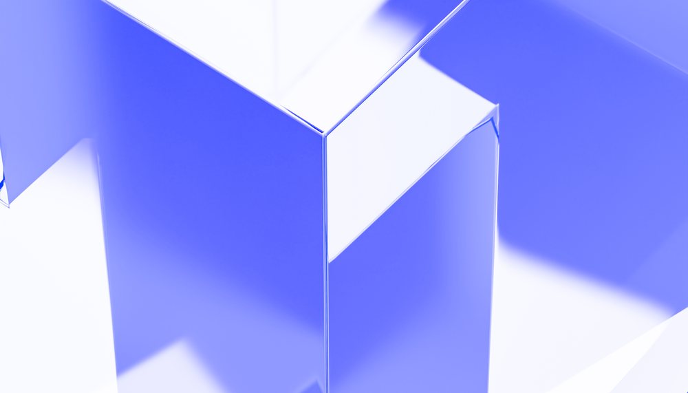 Abstract geometric render featuring blue and white translucent shapes with reflections and sharp edges.