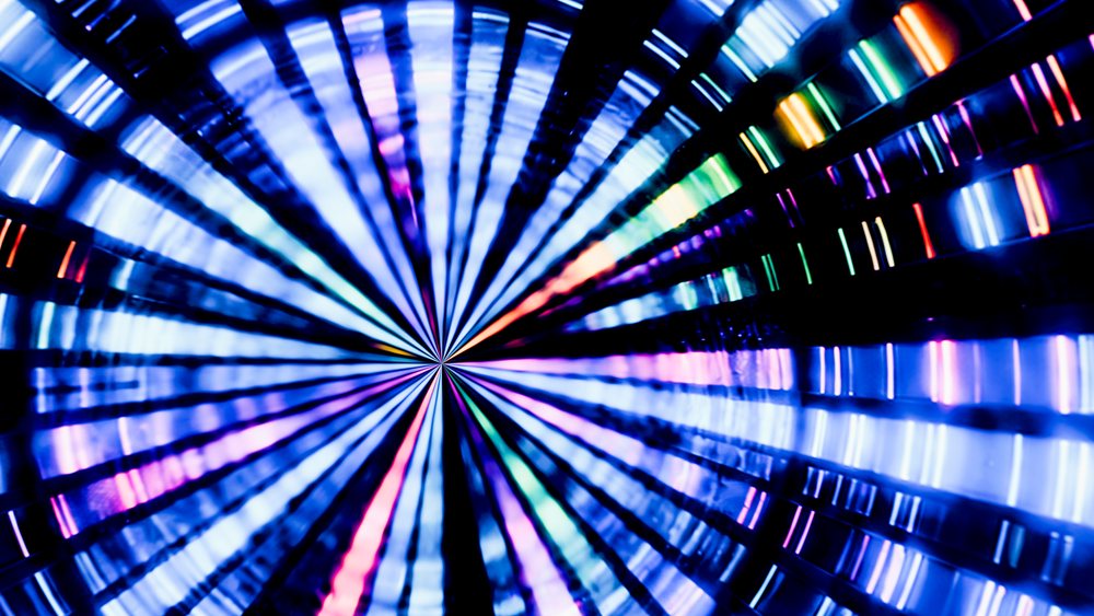 Colorful circular light tunnel with radial lines and glowing multicolor illumination.