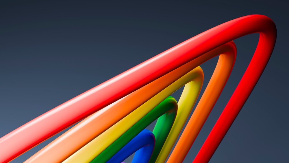 Colorful curved tubes in red, orange, yellow, green, and blue form a vibrant abstract design on a dark gradient background.