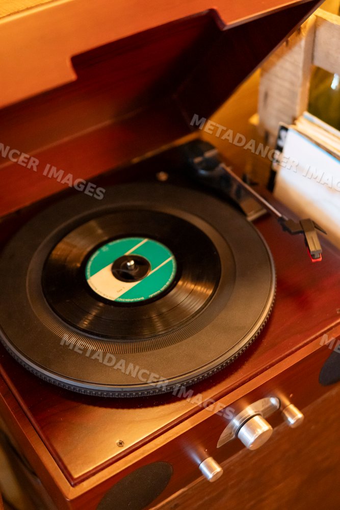 Vinyl record playing on a vintage wooden turntable in Verdun France