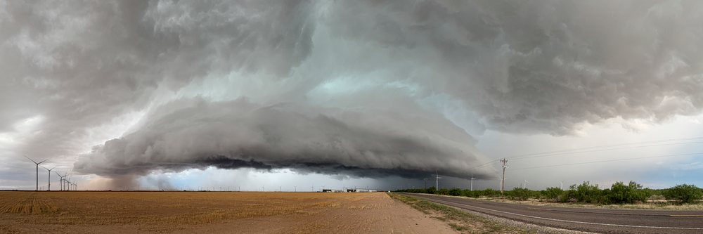 Supercell thunderstorm forming over wind turbines and rural fields in Tornado Alley, Storm Chasing, Garden City, Texas, USA.