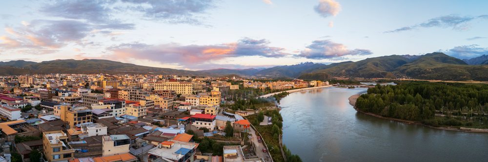 Sunset view of the Garze River flowing through the city of with Kawaluori Mountain rising in the background, Sichuan Province, People's Republic of China.