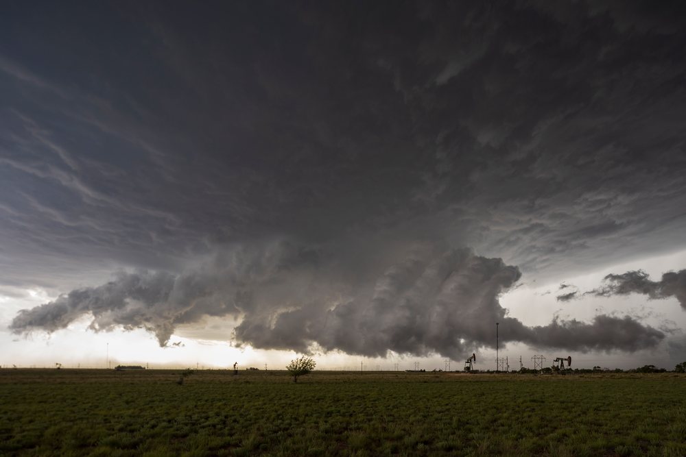 Supercell thunderstorm with multiple tornado funnels forming over a grassy field, Storm Chasing, Levelland, Texas, USA.