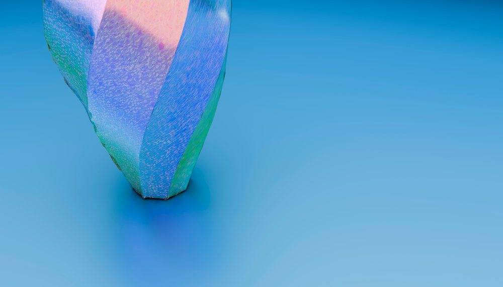 Colorful abstract modern sculpture with textured surface on blue background.
