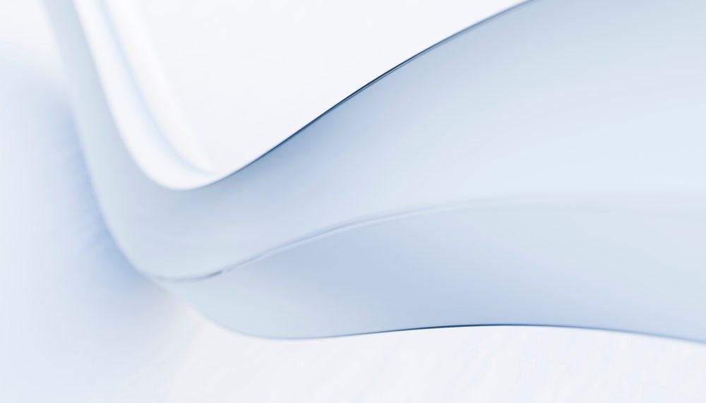 Abstract smooth white curved surfaces with light reflections creating a modern minimalist composition.