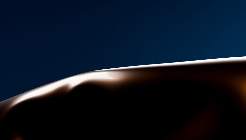 Close-up of smooth melted dark chocolate with glossy surface on a dark background.