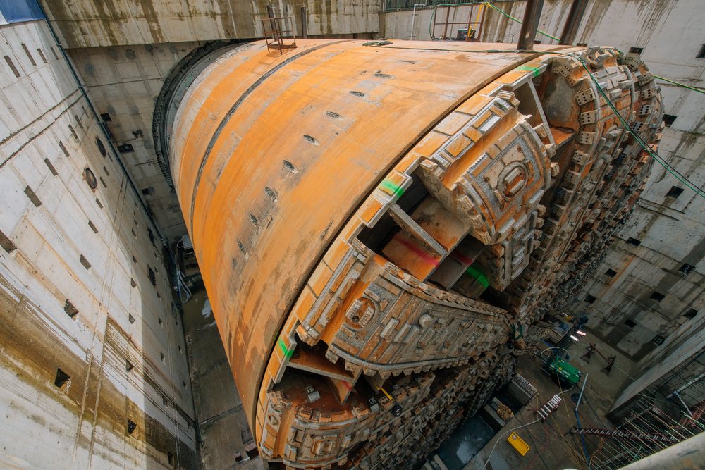 Large tunnel boring machine partially assembled in a deep concrete shaft at a construction site, the tunnel boring machine, drilling, USA.