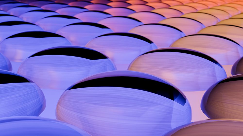 Reflective blue, purple, and orange spheres arranged in a repeating pattern with gradient lighting in a digital 3D illustration.
