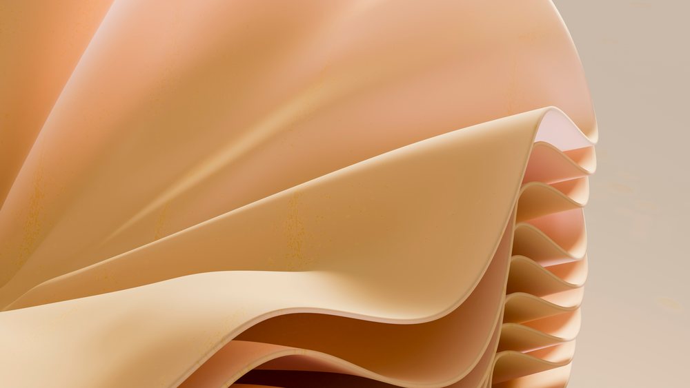 Peach-colored abstract sculpture with smooth curved layers and soft shadows in an art studio.
