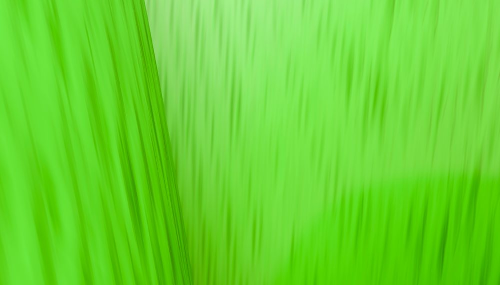 Abstract green textured background featuring blurred lines and vibrant gradient shading.