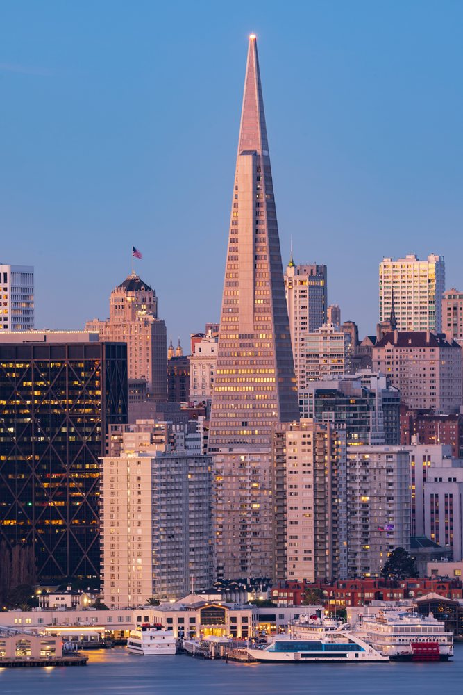 Transamerica building triangular skyscraper at Dawn on the San Francisco waterfront with surrounding high-rise buildings and boats, City, Cityscapes, City Life, California, USA.