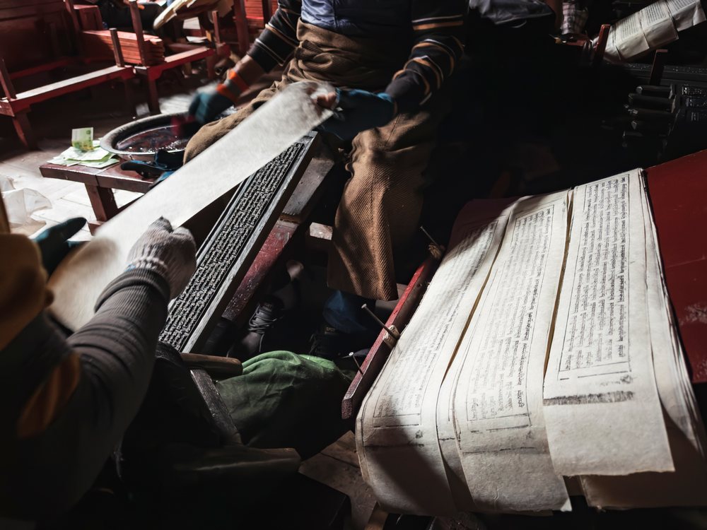 Craftsmen using Tibetan woodblock printing methods produce printed Tibetan Scripts on paper scrolls at Dege Printing Monastery, China, Sichuan Province, People's Republic of China.