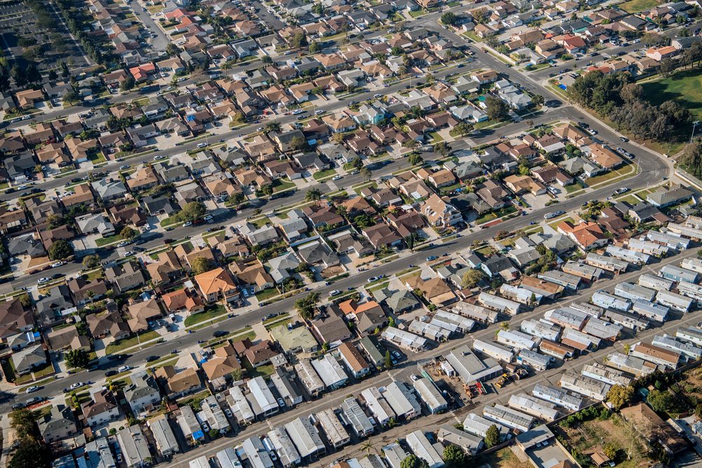 Aerial view of a residential neighborhood showing rows of suburban houses and streets, California, Port of Long Beach, CA, USA.