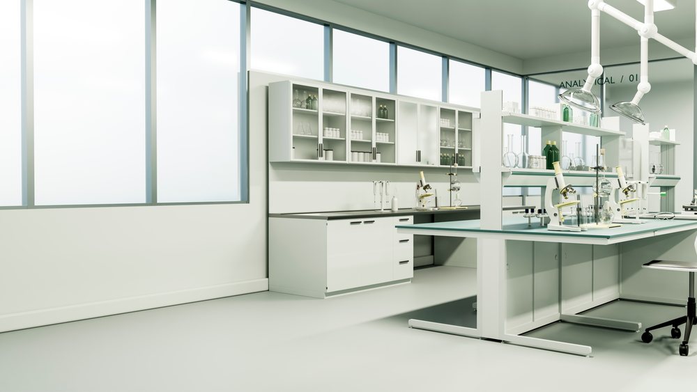 Interior of a scientific laboratory featuring multiple microscopes, chemical glassware, lab benches, cabinets, and a rolling chair under large windows.