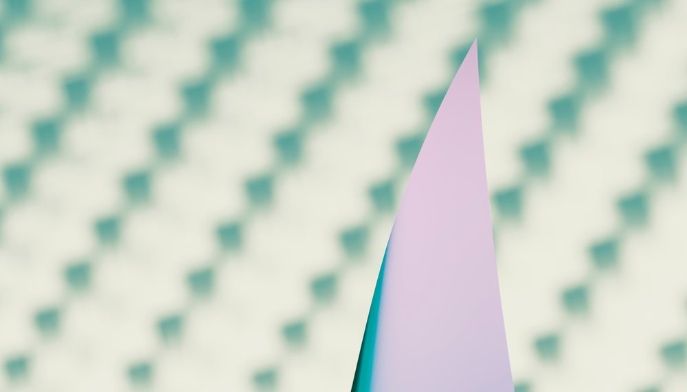 A close-up of a shark dorsal fin breaking through the surface of ocean water.