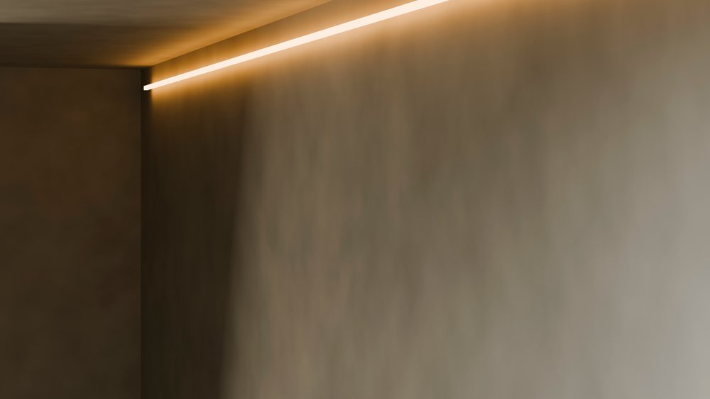 Empty modern room corner featuring ambient ceiling lighting and minimalist brown walls.