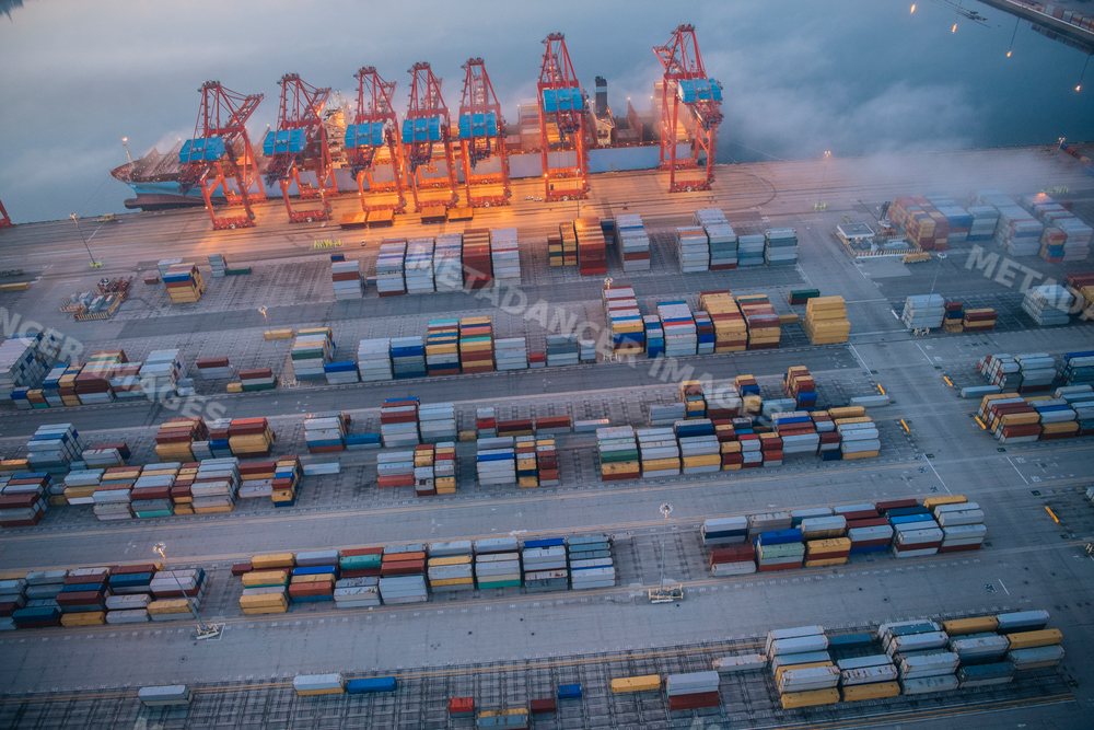 Aerial view of container cranes and shipping containers at a busy port