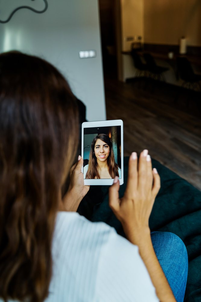 A woman using a tablet for a video call