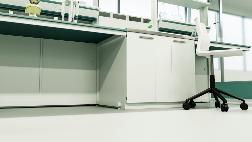 Laboratory desk with white chair and scientific glassware.