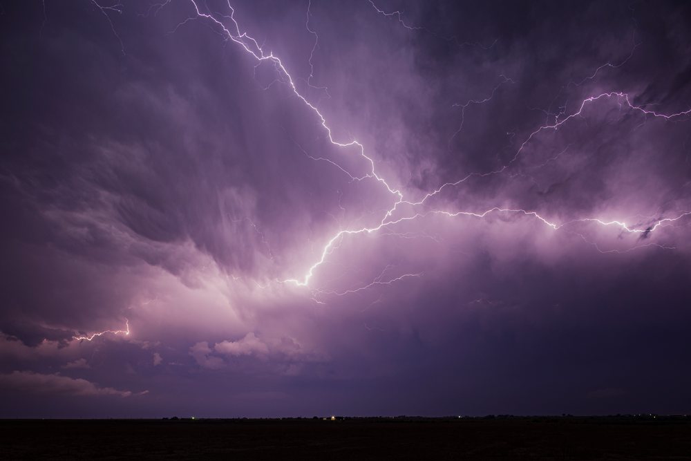 Lightning bolts illuminate a stormy night sky over the flat landscape of La Junta in the Midwest Tornado Alley of the, Storm Chasing, Weather, Environment, Colorado, USA.