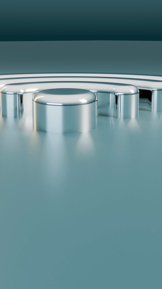 Close-up of a shiny metal gear with evenly spaced teeth in industrial machinery.