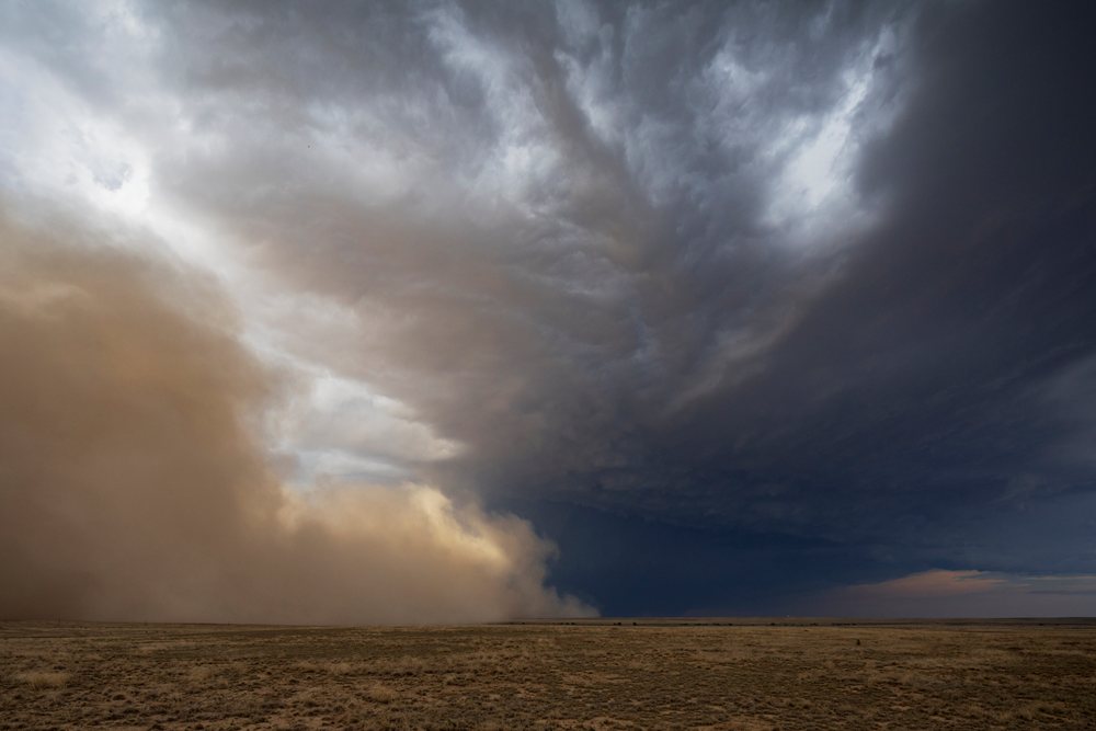 Dust Storm advances over a dry open field under dark Storm clouds, Storm Chasing, Weather, Environment, Fowler, Colorado, USA.