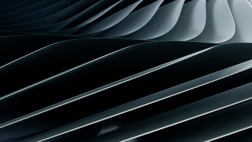 Curved black metal sheets arranged in smooth overlapping layers form an abstract industrial design.
