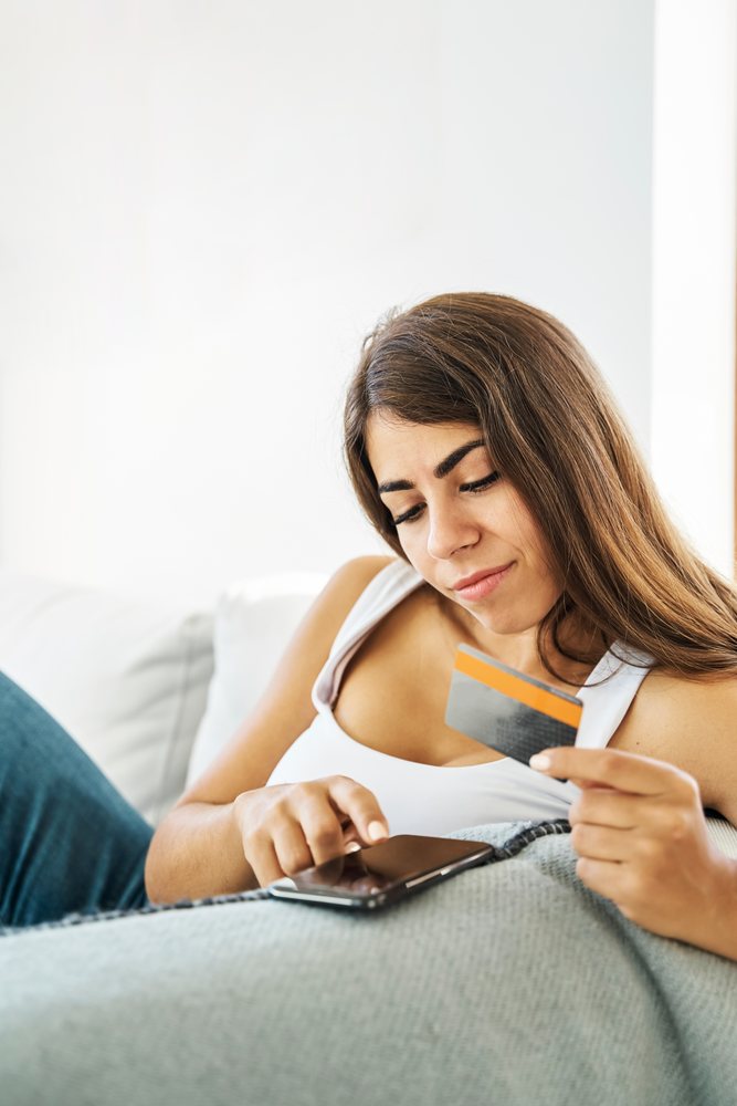 A white woman comfortably shops online