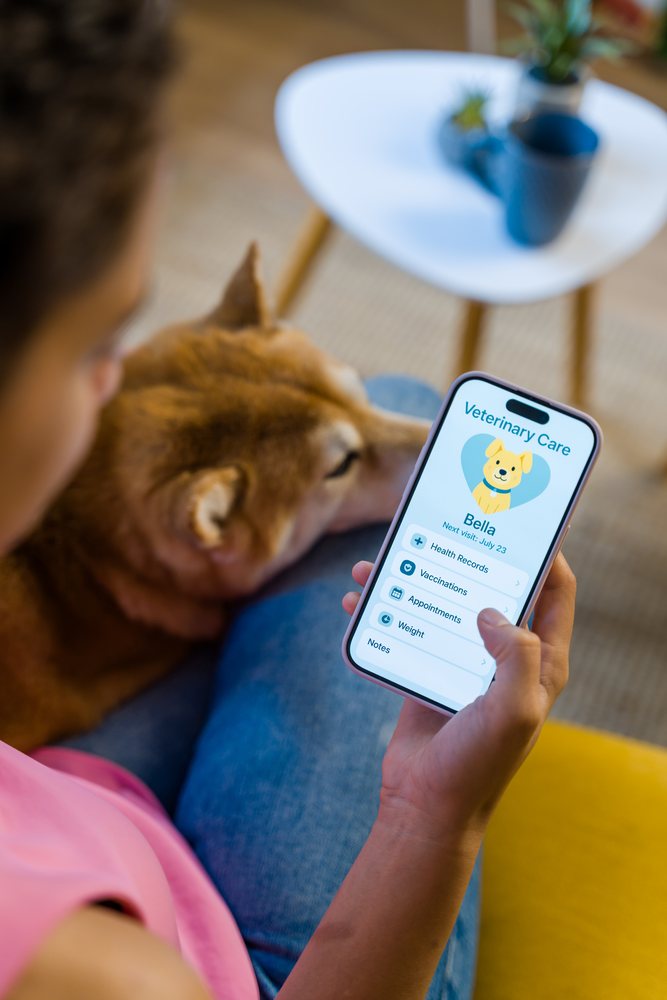A person at home in Spain is using a veterinary care mobile app to check health records and appointments for their dog.