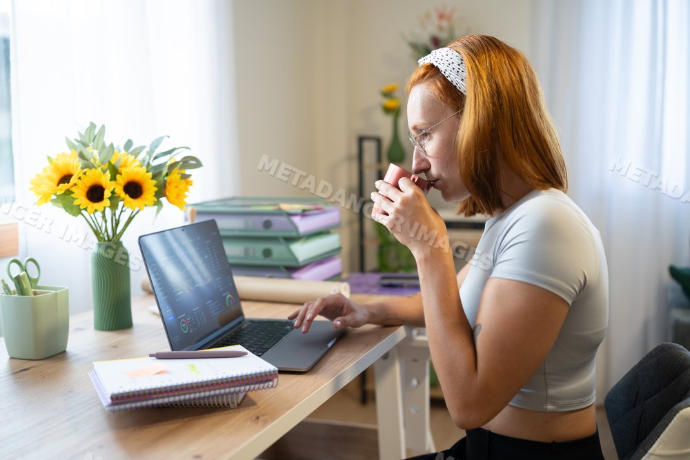 Young white woman telecommuting with coffee