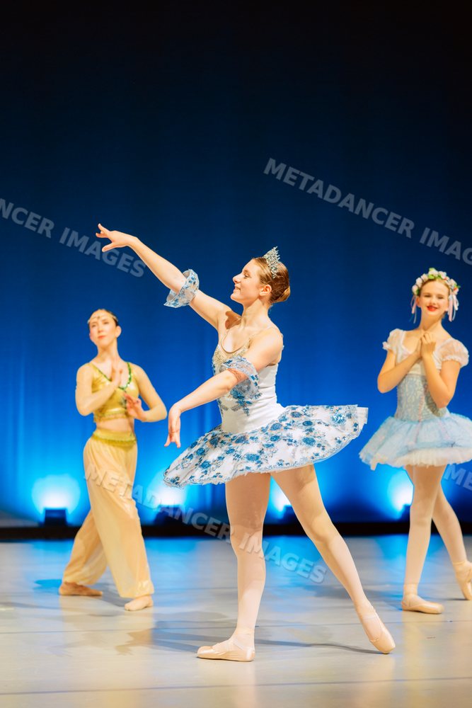 A ballerina performs a graceful dance on stage during a ballet recital