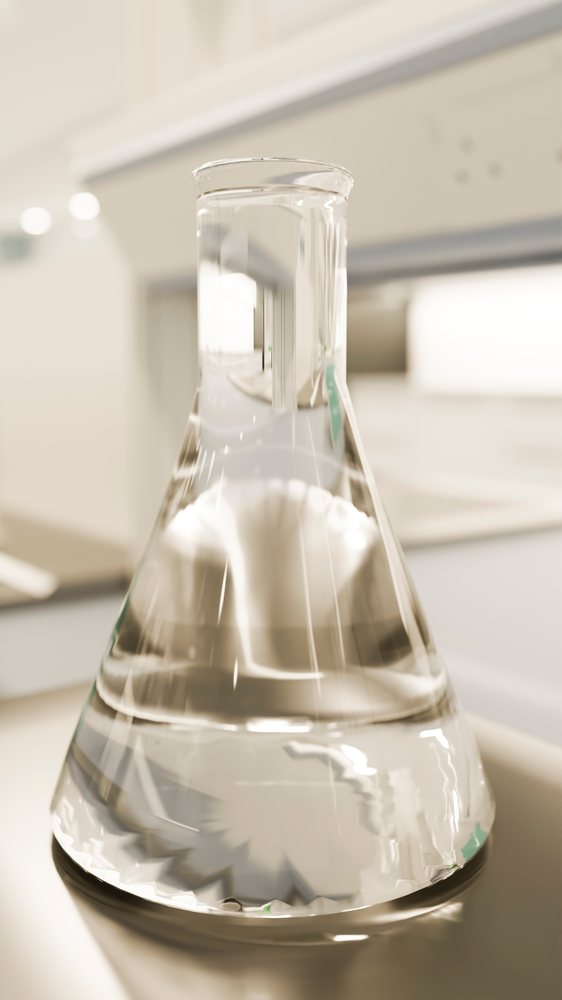 Erlenmeyer flask containing clear liquid on a laboratory bench in a scientific research environment.