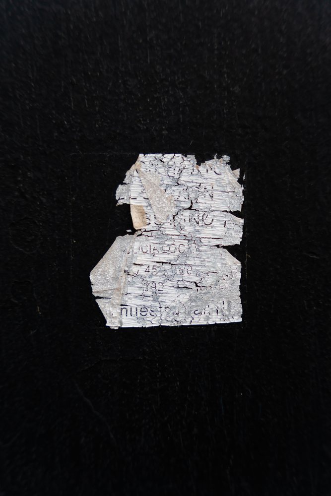 Weathered black surface with cracked and peeling white paint creating an abstract textured background, texture, abstract texture, wallpaper, Spain.