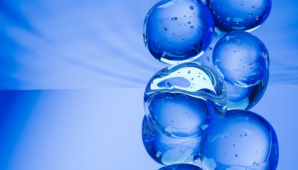 Cluster of transparent blue bubbles arranged against a blue gradient abstract background with visible surface reflections.
