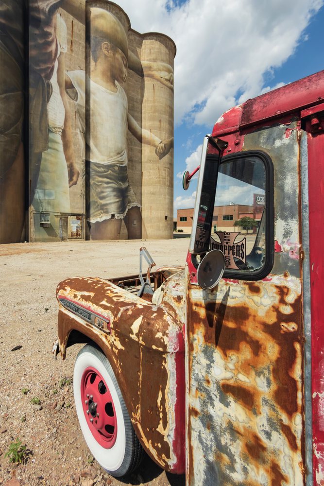 Rusty vintage Chevrolet Apache truck parked near a Grain Silo, Storm Chasing, Weather, Environmental Issues, Salina, Kansas, USA.