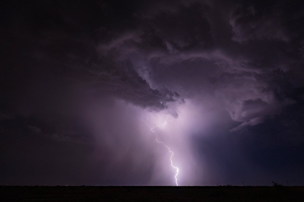 Lightning strikes amid dark Storm clouds during a Haboob at night with a flat horizon landscape, Storm Chasing, Weather, Environmental Issues, McNeal, Arizona, USA.