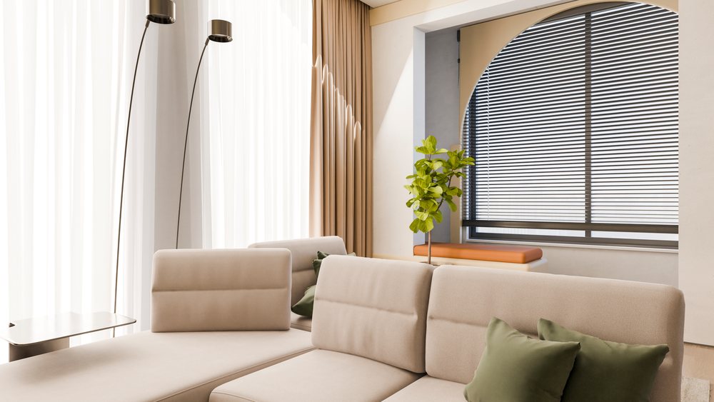 Modern beige sofa with green pillows in minimalist living room.