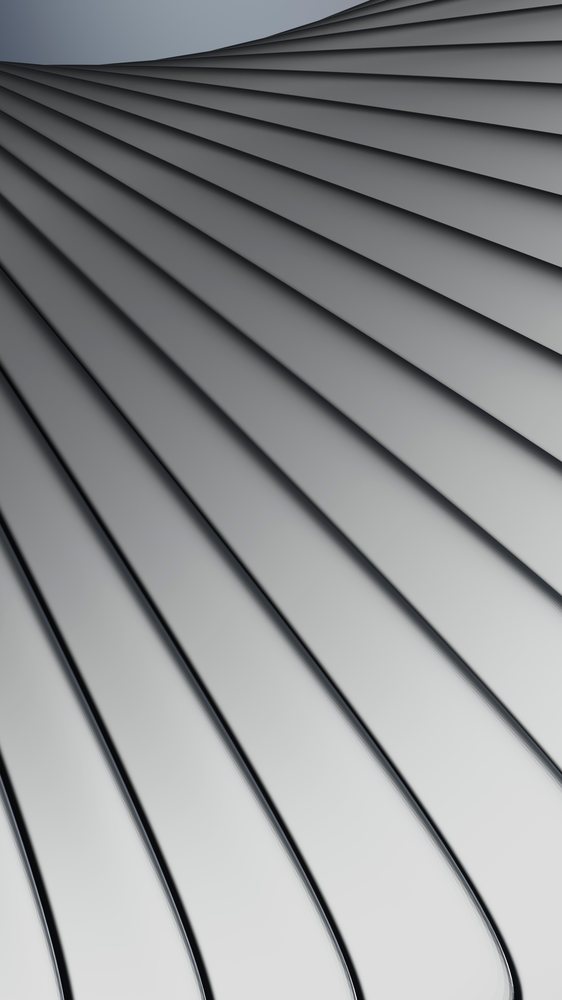 Close-up of multiple overlapping stainless steel spoons with reflective, smooth metal surfaces arranged in a repeating pattern.