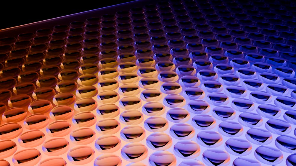 Abstract digital illustration of a curved surface covered with symmetrical spherical lenses in orange and blue gradient tones.