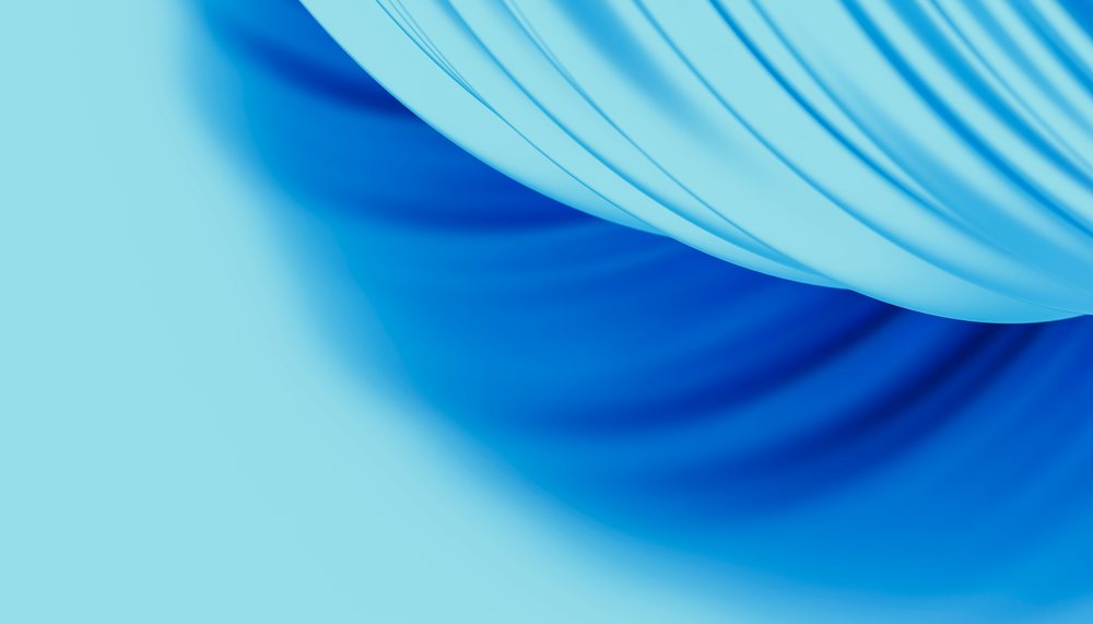 Blue fabric with soft flowing folds and curved lines creating a smooth textured background.