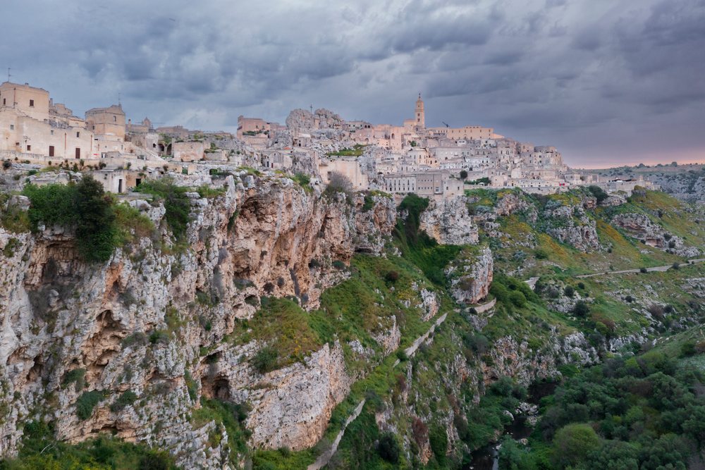 Sasso Caveoso hilltop town with historic buildings on cliffs and cloudy sky at Dawn, Matera, Basilicata, Italy.