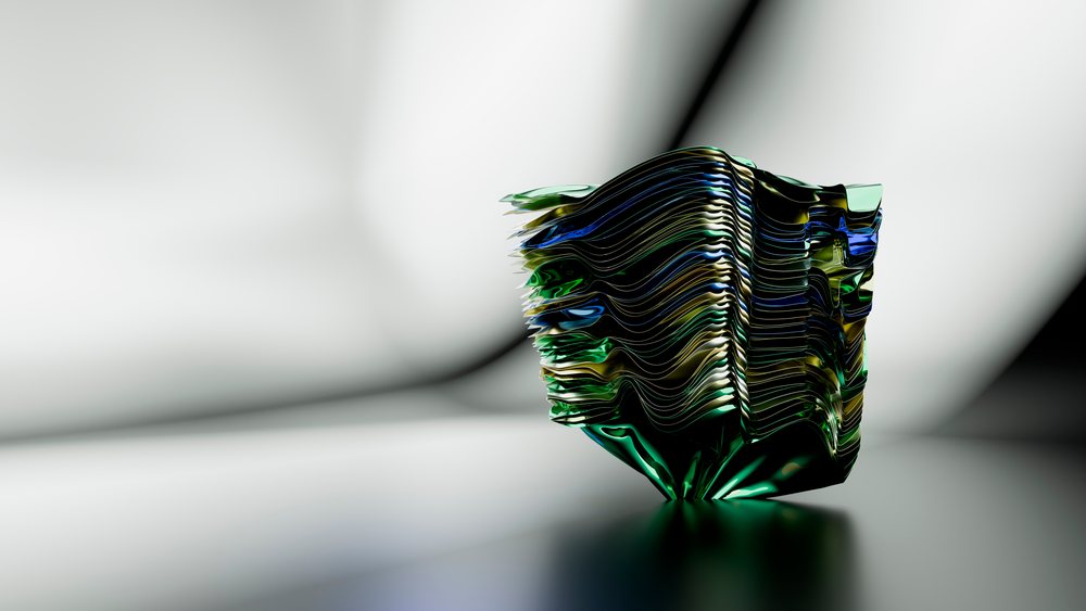 Abstract sculpture featuring colorful layered waves and fluid lines on a smooth studio surface.