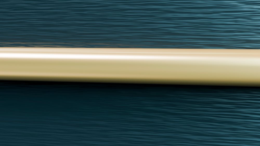 Horizontal beige tube floats on a calm blue water surface with gentle ripples and reflections.
