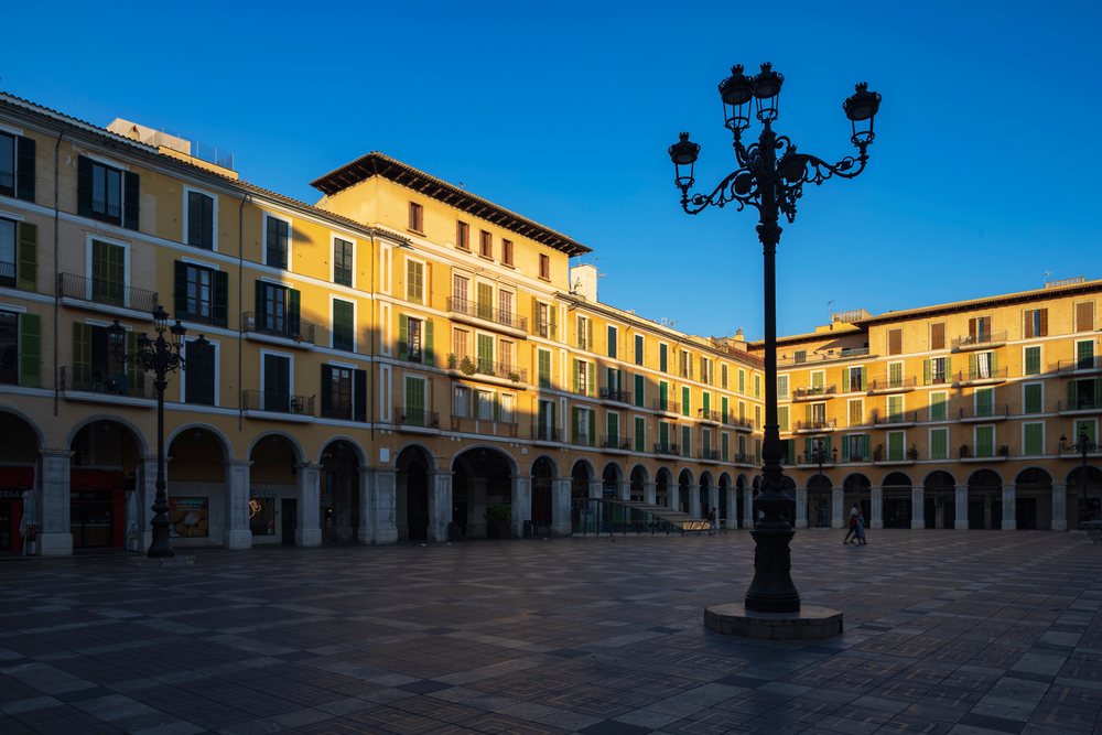 Sunrise over plaça major square with historic buildings, arches, and street lamps, Landscape, Lifestyle, Palma de Mallorca, Balearic Islands, Spain.
