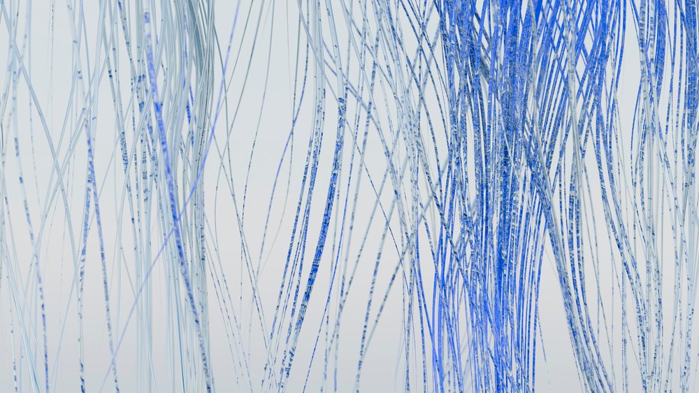 Blue thin transparent strings hanging vertically forming an abstract pattern on a light background.