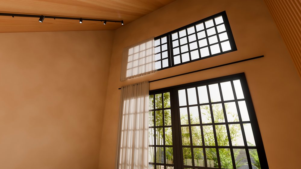 Large windows with black frames and sheer curtains illuminate a modern interior.