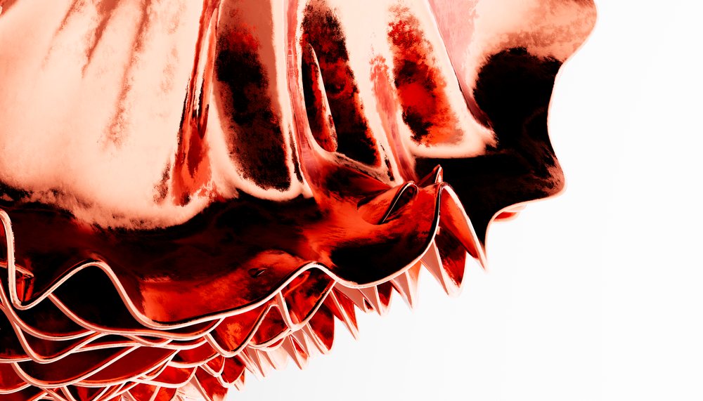 Close-up of a red-toned dinosaur skull showing detailed dental structure against a white background.