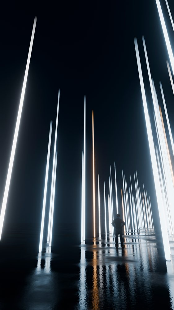 Man standing amidst vertical glowing light pillars reflected on a dark reflective surface at night.