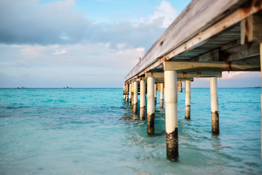 Wooden pier extending over turquoise ocean water